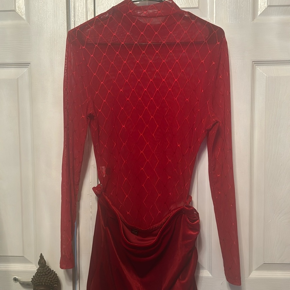 red lace bodysuit paired with a suede mini skirt.